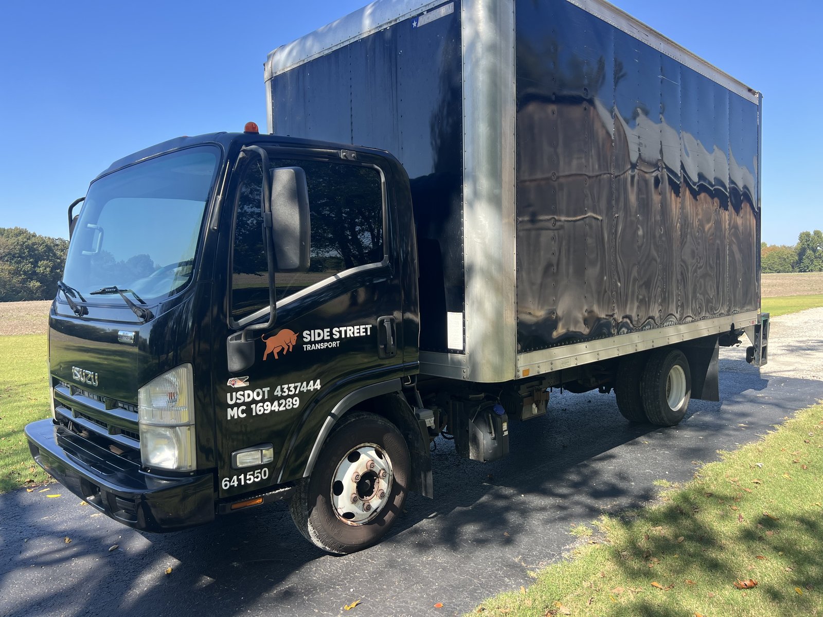 2014 Isuzu NPR HD box truck, driver side front view