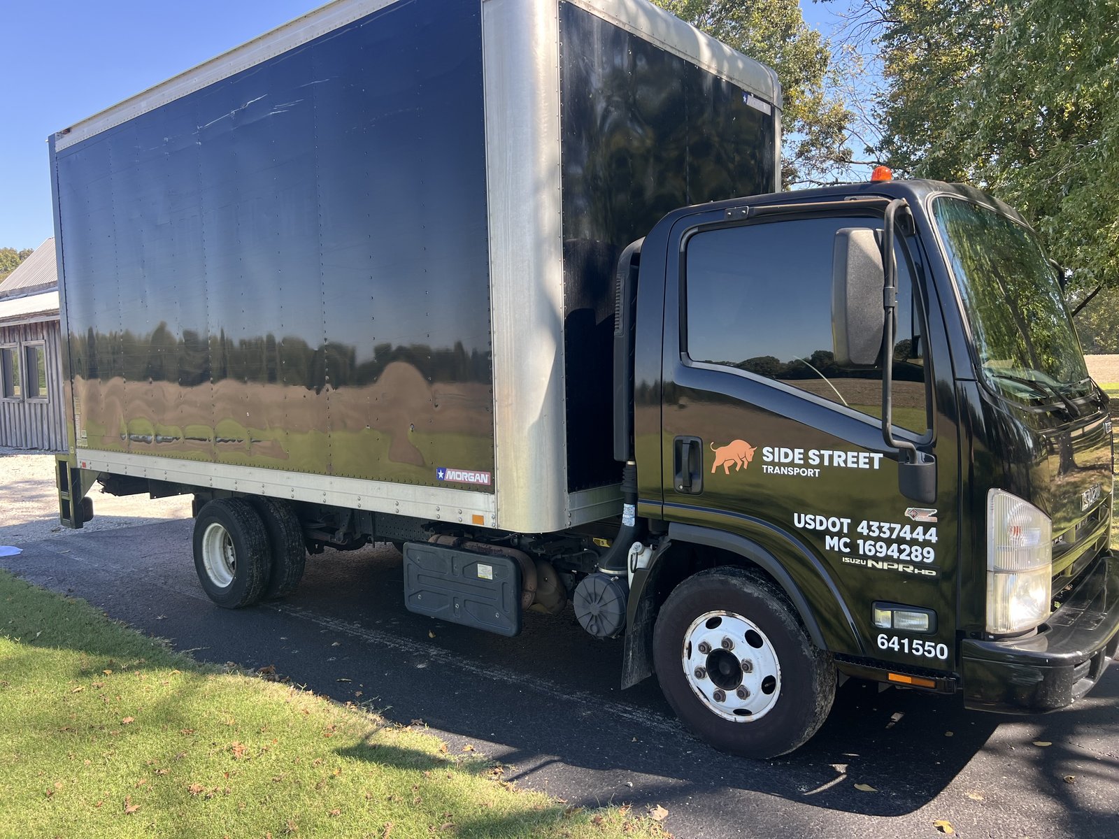 2014 Isuzu NPR HD box truck, rear three-quarter view